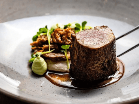 Close-up van een luxe maaltijd met vlees en groenten op een bord